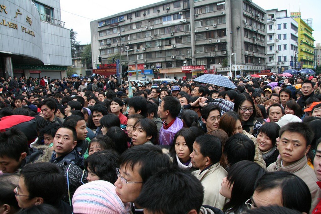 Over 100,000 people were stranded at Guangzhou station in China as unusually cold weather caused delays over Lunar New Year – the busiest travel time of the year. Image: “Crazy crowds, Guangzhou train station” by Tom Booth licensed under Creative Commons via flickr.